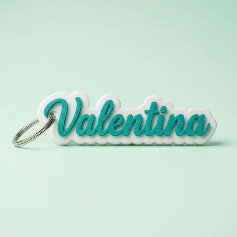 Llavero con el nombre Valentina en letras cursivas turquesas sobre base blanca